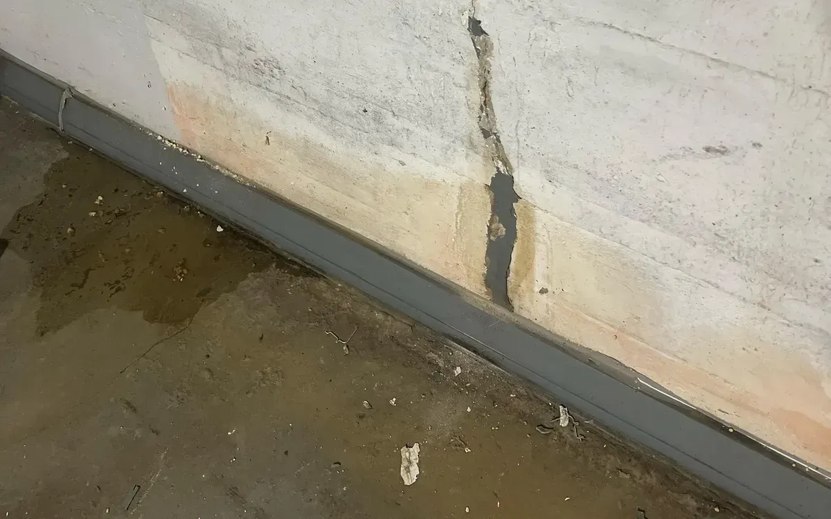 Cracked foundation wall with seepage staining, the entry point basement waterproofing in Syracuse seals